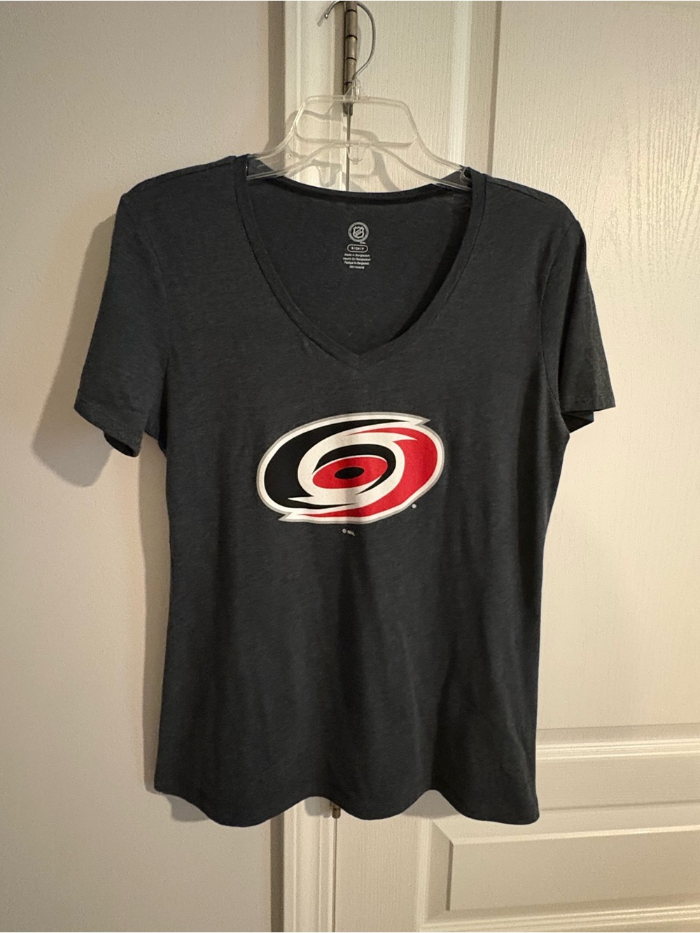NHL Hurricanes Women's V-Neck Tee with Red & White Hockey Emblem